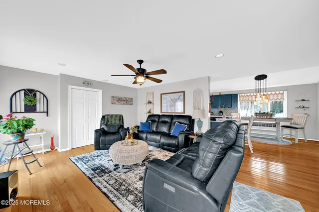 a living room with furniture and wooden floor