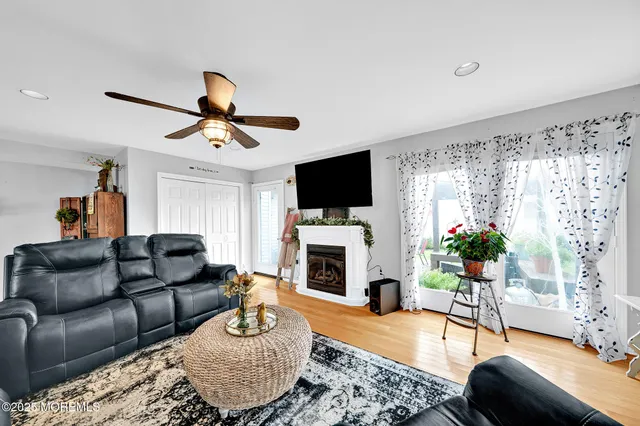 a living room with furniture a fireplace and a flat screen tv