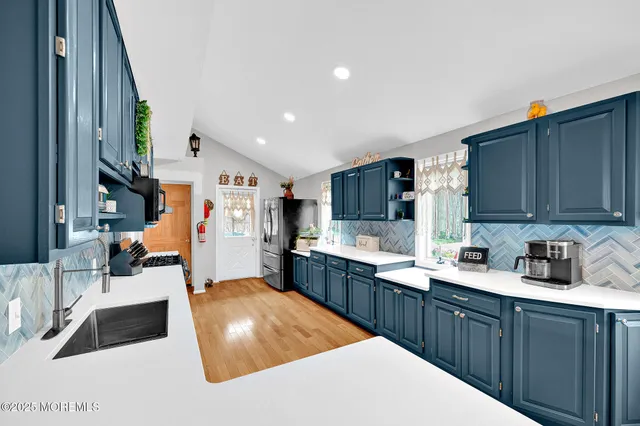 a kitchen with stainless steel appliances kitchen island granite countertop a sink dishwasher stove and cabinets