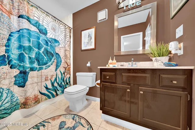 a bathroom with a sink a toilet and mirror