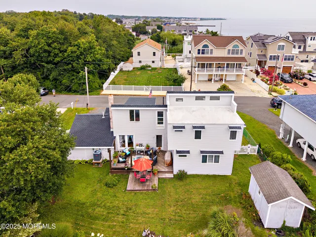 an aerial view of a house with swimming pool garden and mountain view
