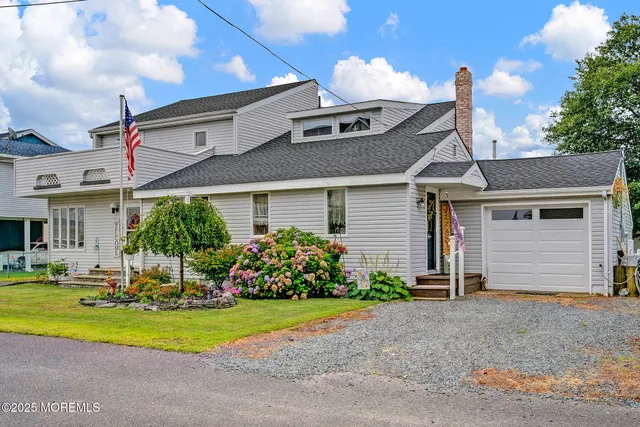 a front view of a house with a yard and outdoor seating