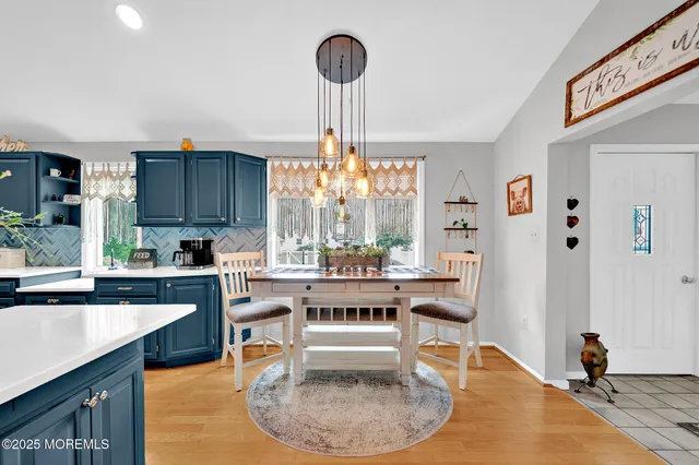 a living room with stainless steel appliances granite countertop furniture a couch and a large window
