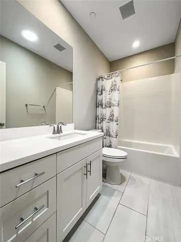 a bathroom with a double vanity sink toilet and a bathtub