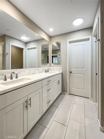 a spacious bathroom with a mirror sink and shower