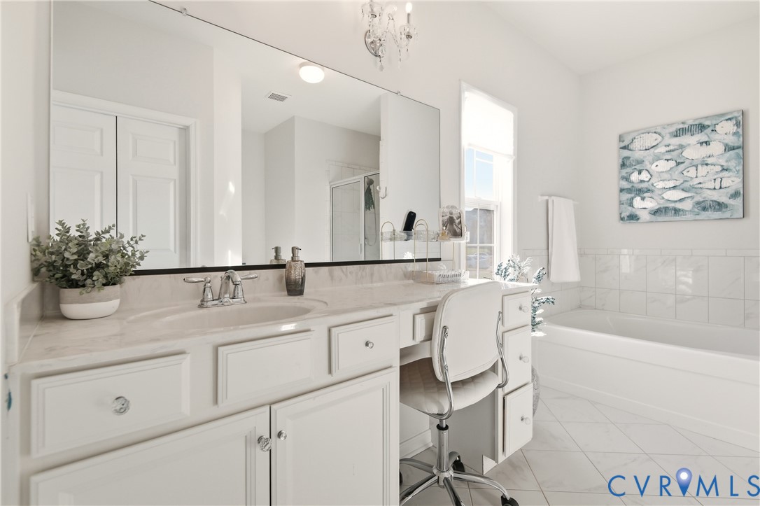 11201 Avening Road Midlothian, VA 23112 - Photo 13 of 20 a bathroom with a sink a large mirror and a bathtub