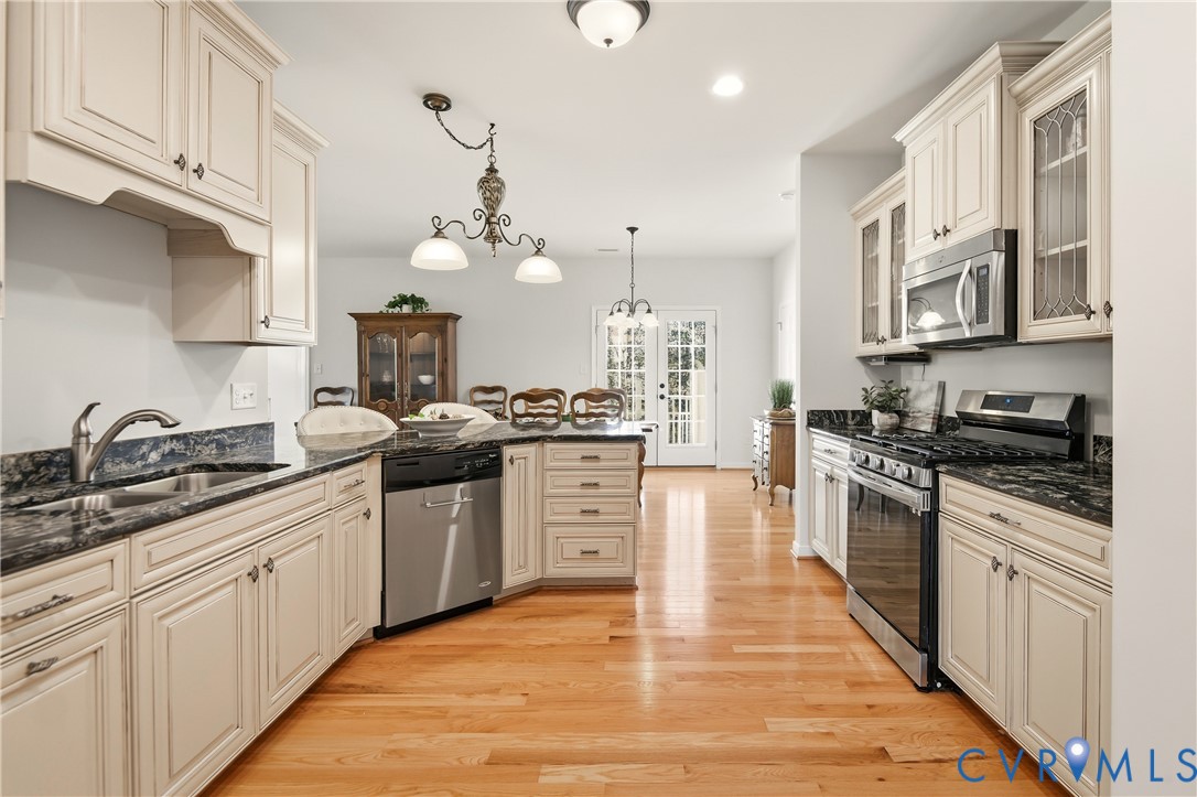 11201 Avening Road Midlothian, VA 23112 - Photo 4 of 20 a kitchen with white cabinets stainless steel appliances and sink