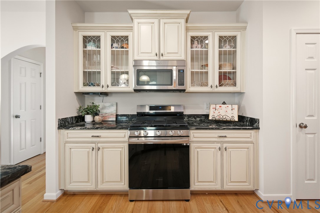 11201 Avening Road Midlothian, VA 23112 - Photo 6 of 20 a kitchen with stainless steel appliances granite countertop white cabinets and stove top oven