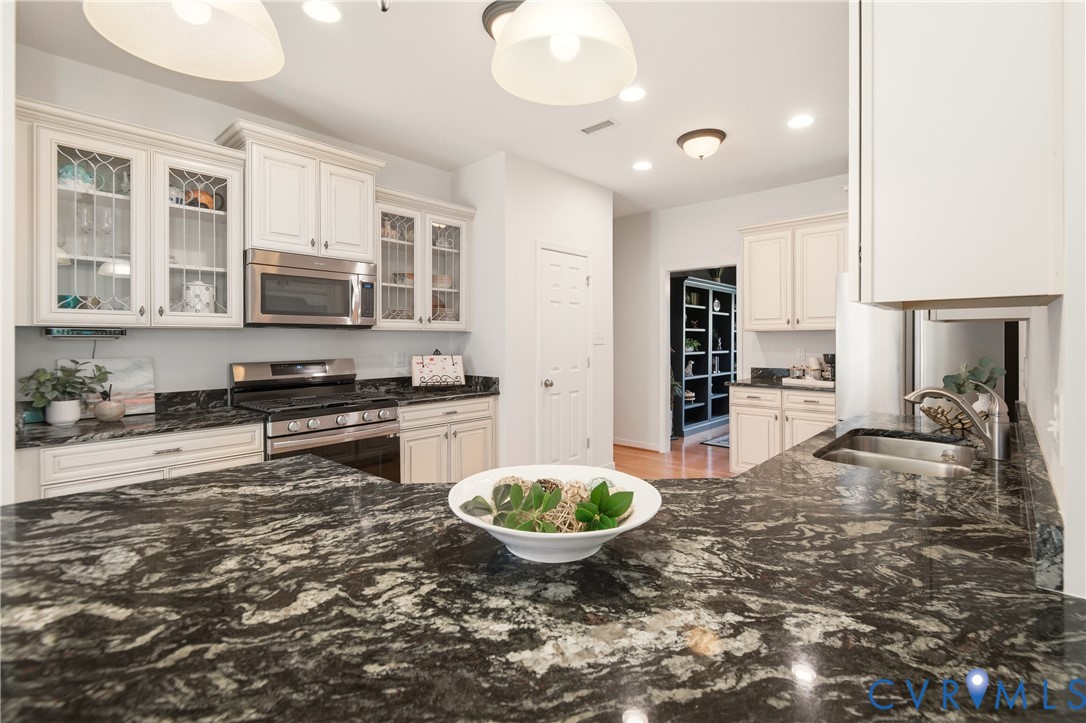 11201 Avening Road Midlothian, VA 23112 - Photo 8 of 20 a kitchen with stainless steel appliances a stove a sink and a refrigerator