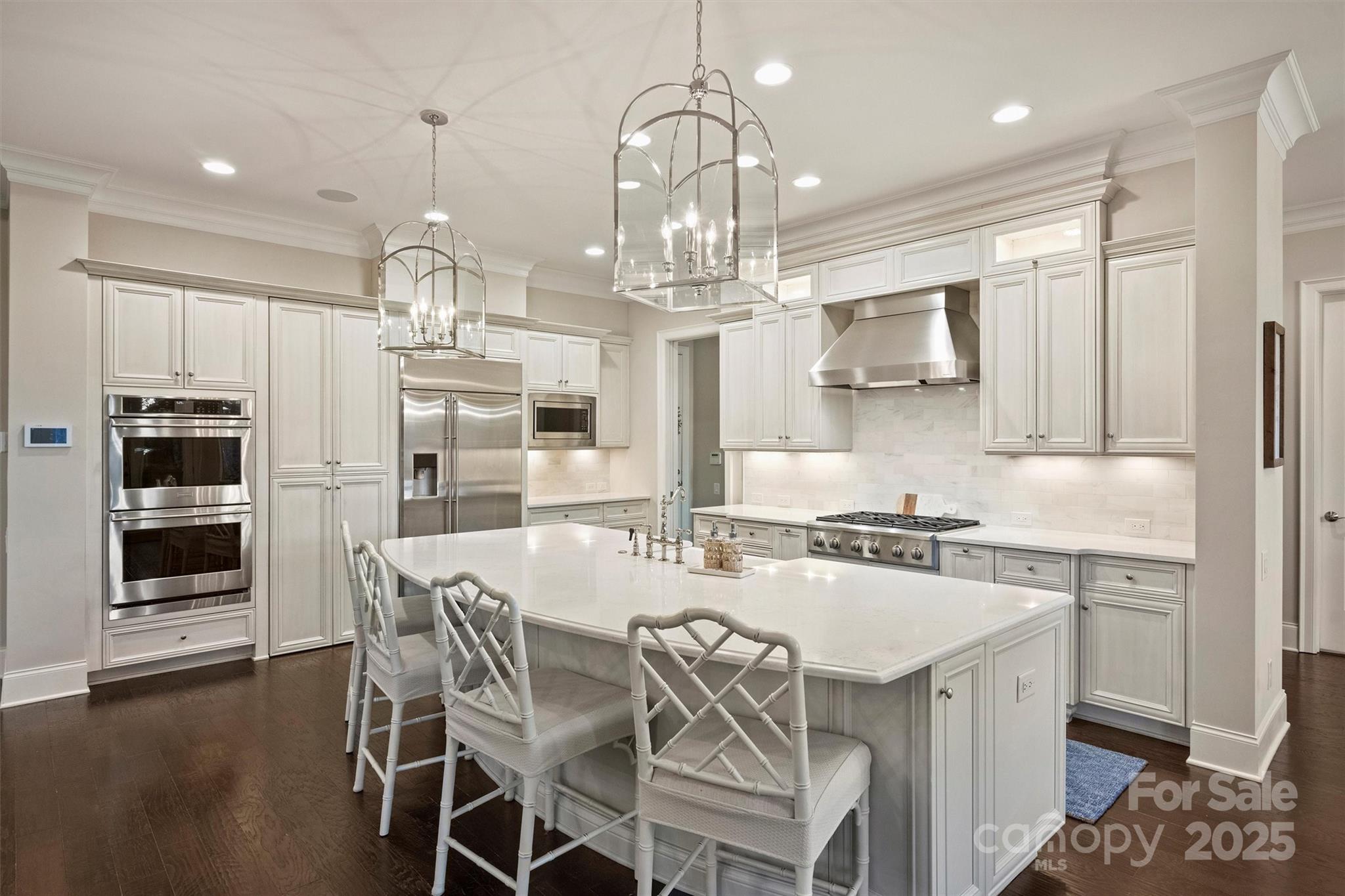 17639 Stuttgart Road Davidson, NC 28036 - Photo 19 of 48 a kitchen with stainless steel appliances a kitchen island a stove a table and chairs in it