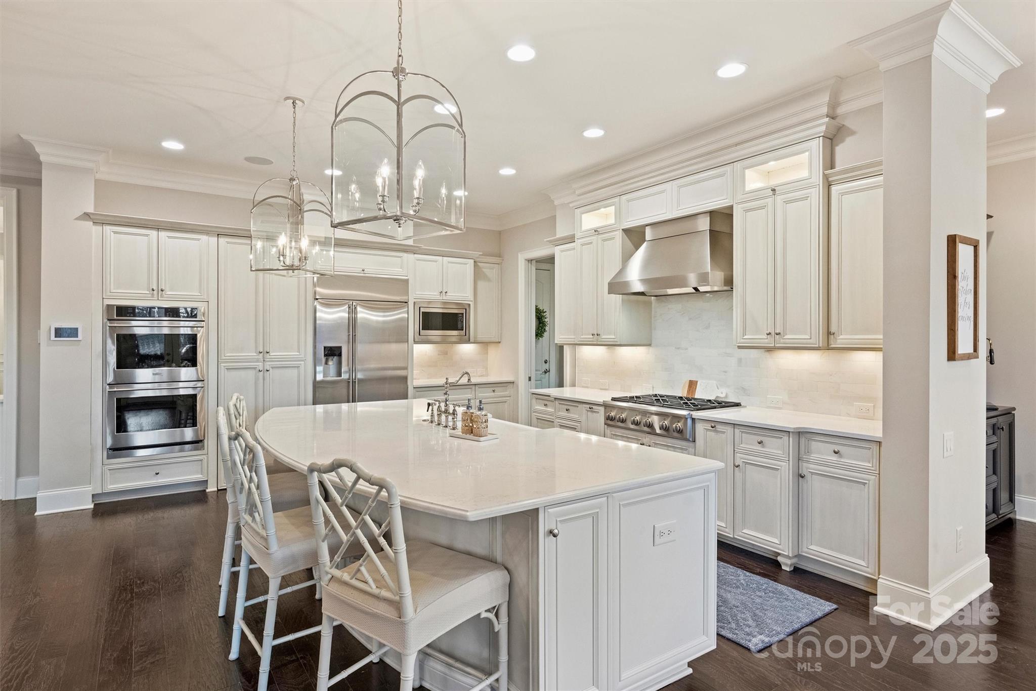 17639 Stuttgart Road Davidson, NC 28036 - Photo 20 of 48 a kitchen with stainless steel appliances granite countertop a stove top oven a sink dishwasher and white cabinets with wooden floor