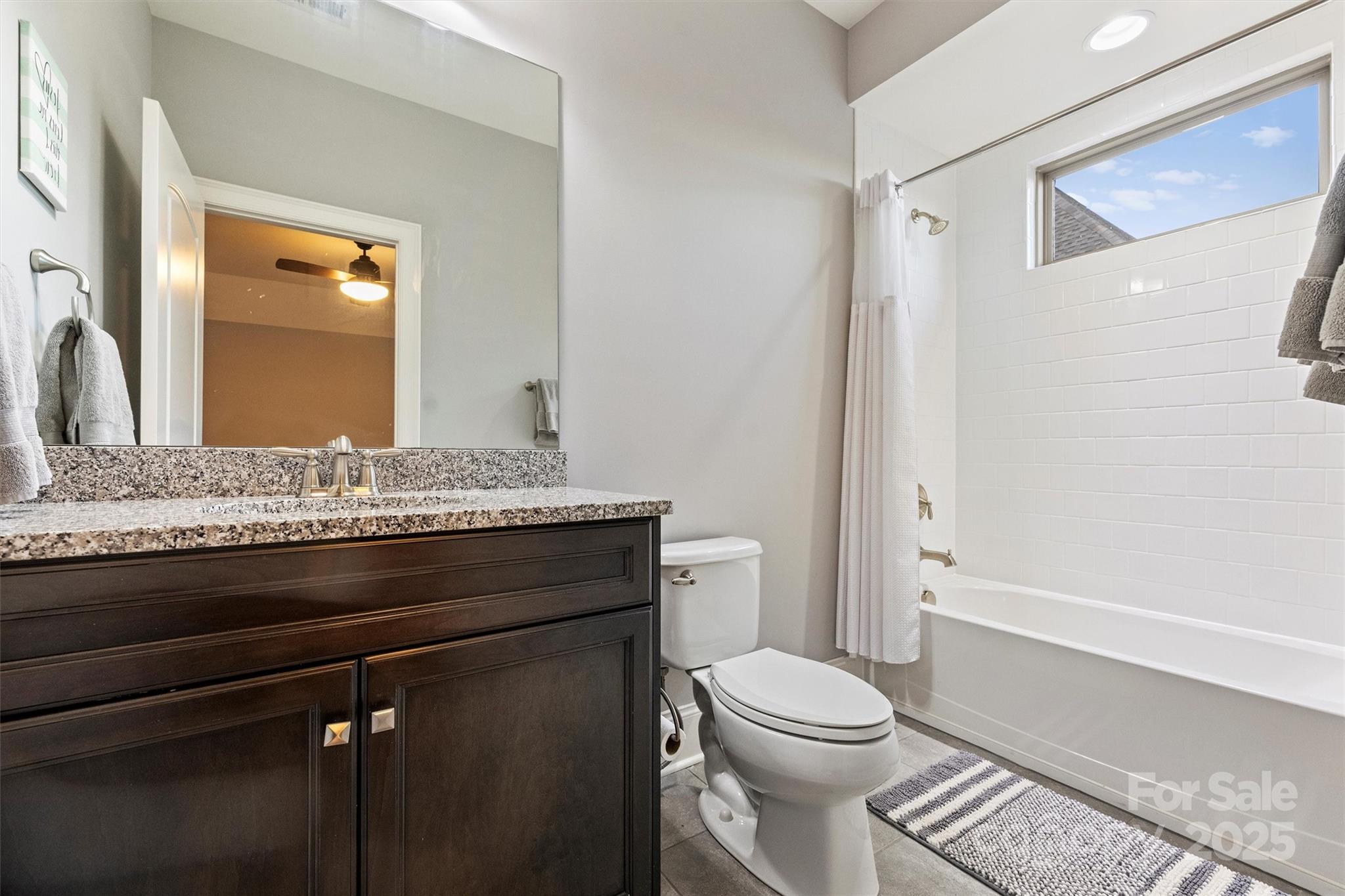 17639 Stuttgart Road Davidson, NC 28036 - Photo 35 of 48 a bathroom with a granite countertop toilet sink and mirror