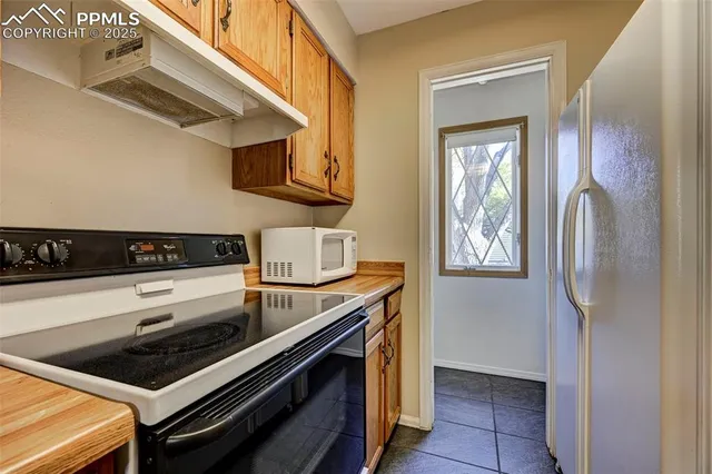 a kitchen with stainless steel appliances granite countertop a stove and a refrigerator