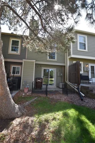 a view of a house with a yard and sitting area
