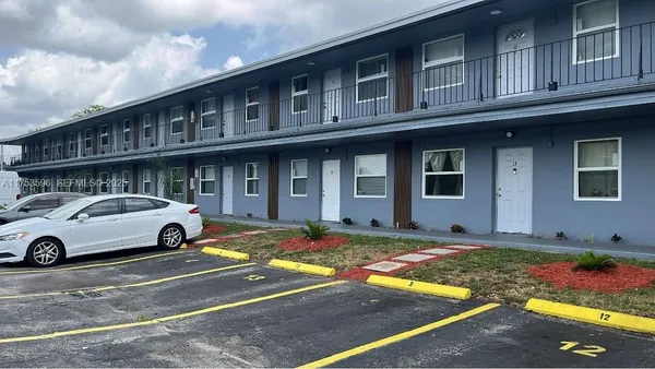 a front view of a house with parking space