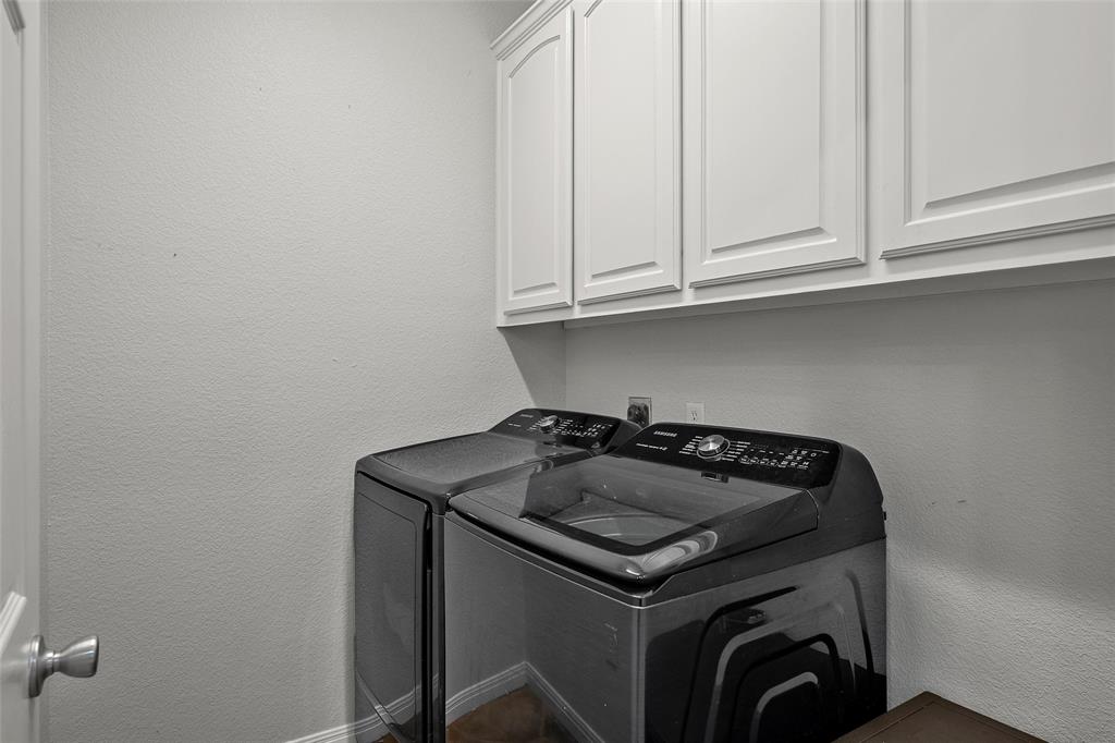 3696 Old Lorena Road Lorena, TX 76655 - Photo 15 of 27 Dedicated laundry space featuring white upper cabinetry, wood-finish flooring, and light-toned walls