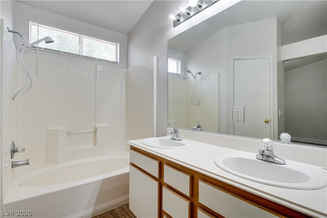 9660 Crystal Ridge Road Las Vegas, NV 89123 - Photo 9 of 13 Dual vanities complement a bright bath with a large mirror and window over the tub.
