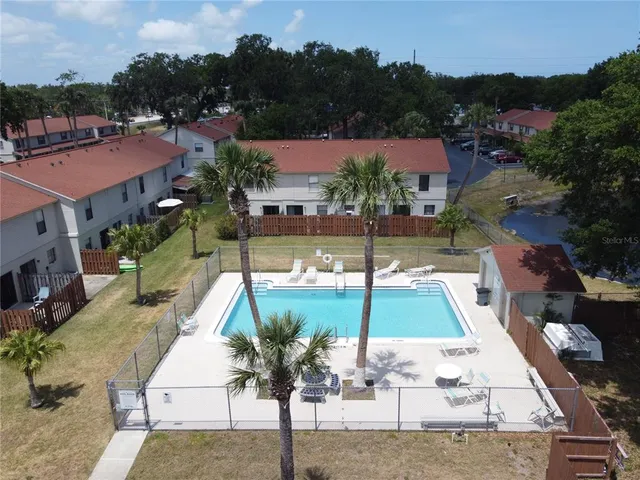 an aerial view of residential houses with outdoor space