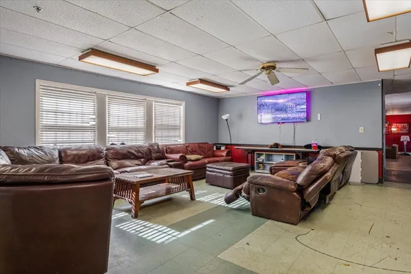 a living room with furniture a rug and a window