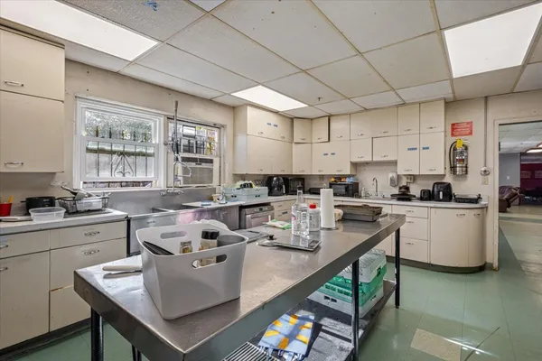 a living room with stainless steel appliances furniture a kitchen view living room and a window