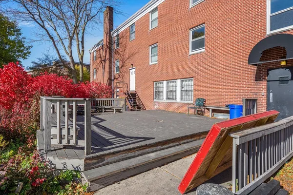 a view of house with deck and outdoor seating
