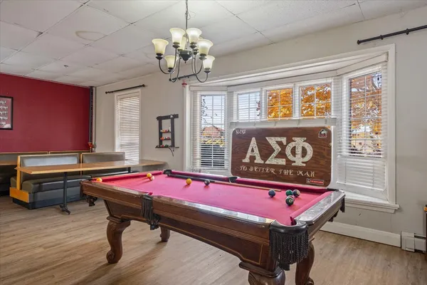 a room with pool table and windows