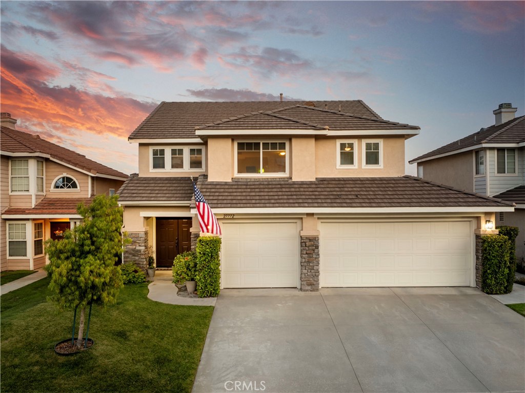 27772 Ron Ridge Drive Saugus, CA 91350 - Photo 1 of 1 a front view of a house with a yard and garage