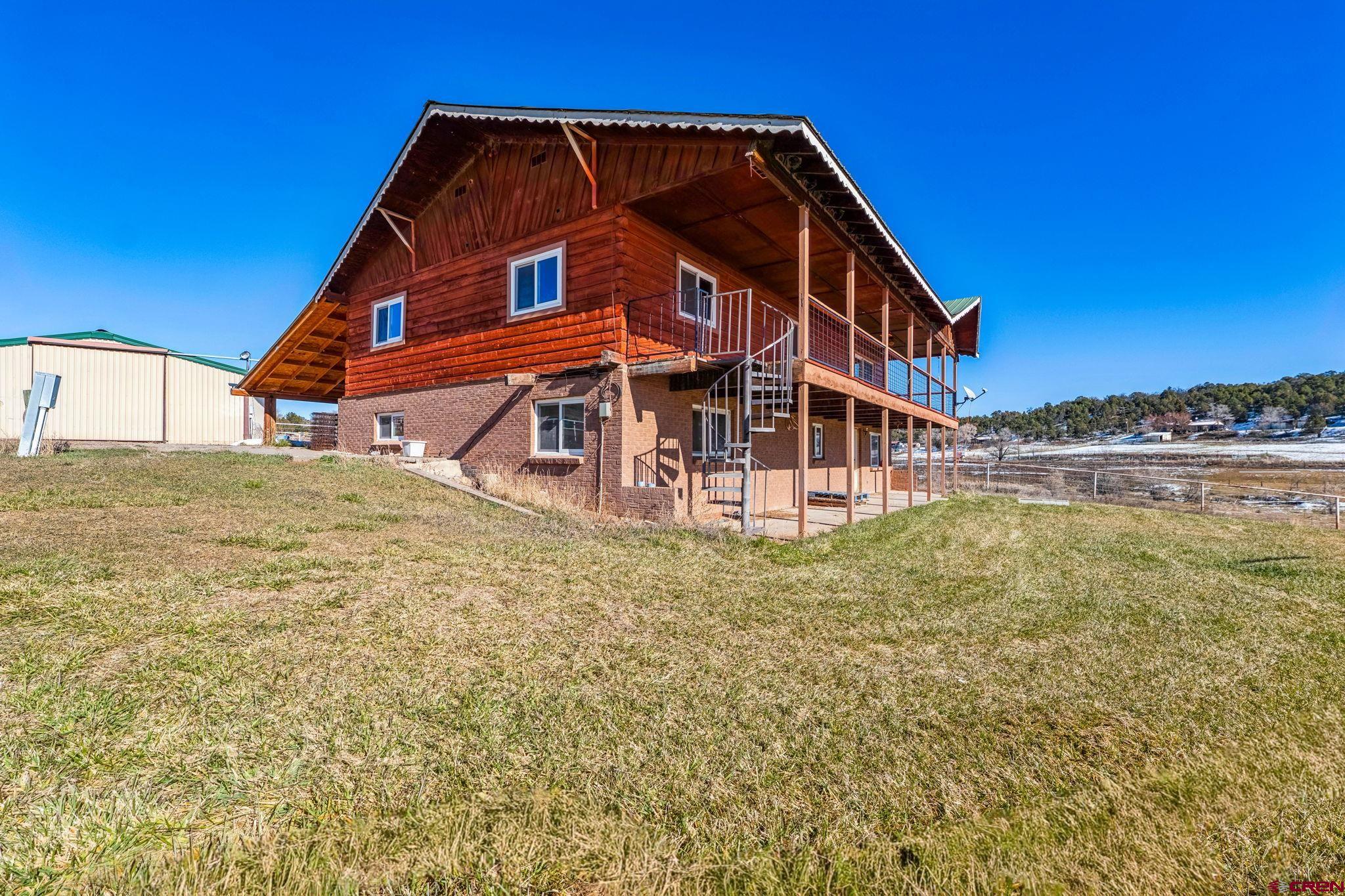 124 Meadow Road Ignacio, CO 81137 - Photo 11 of 37 a view of a house with a small yard and a large window