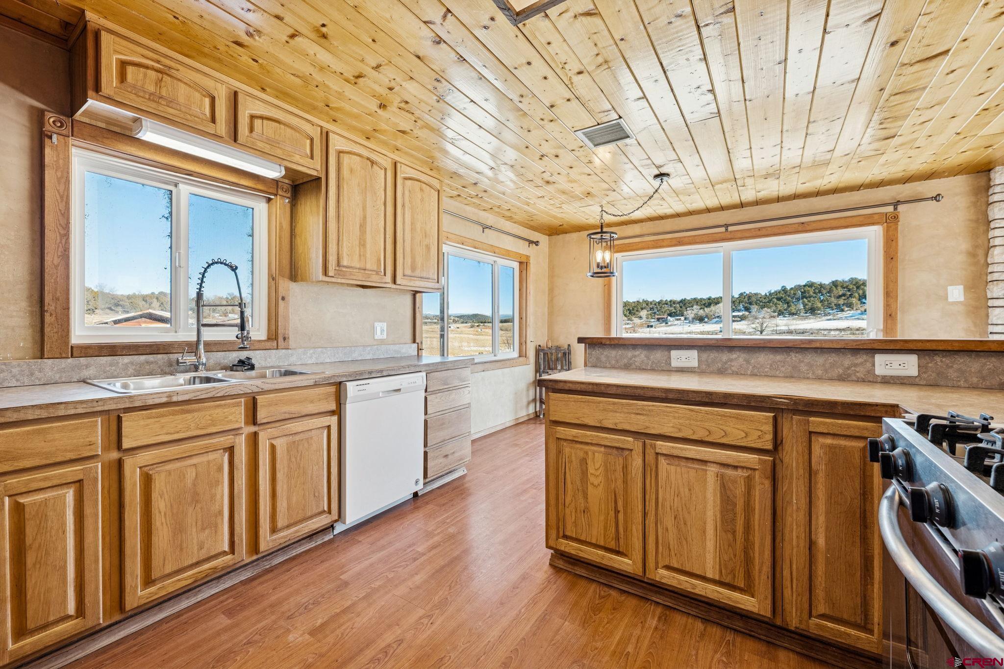 124 Meadow Road Ignacio, CO 81137 - Photo 28 of 37 a kitchen with stainless steel appliances granite countertop wooden cabinets and a stove top oven