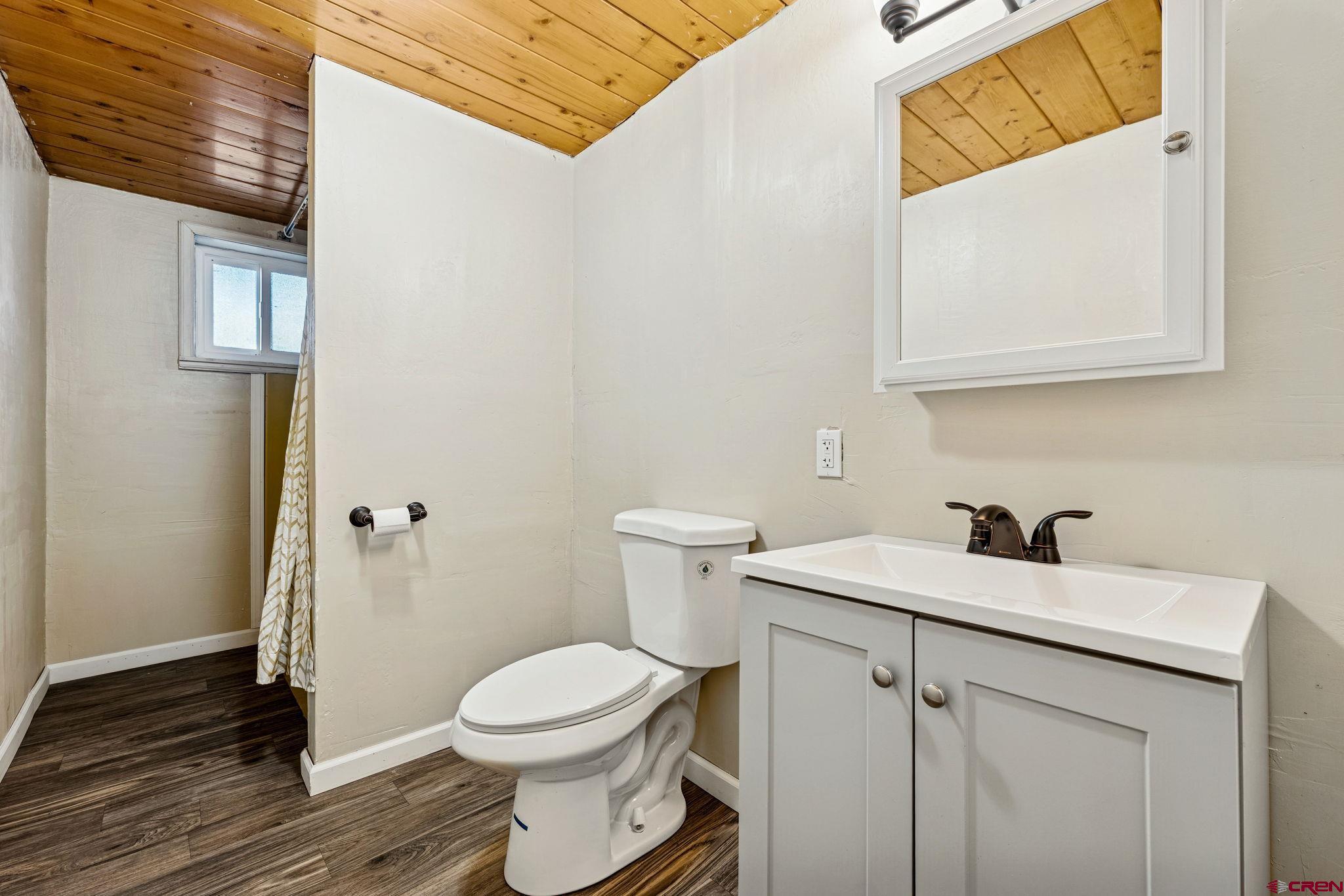 124 Meadow Road Ignacio, CO 81137 - Photo 31 of 37 a bathroom with a sink a toilet and a mirror