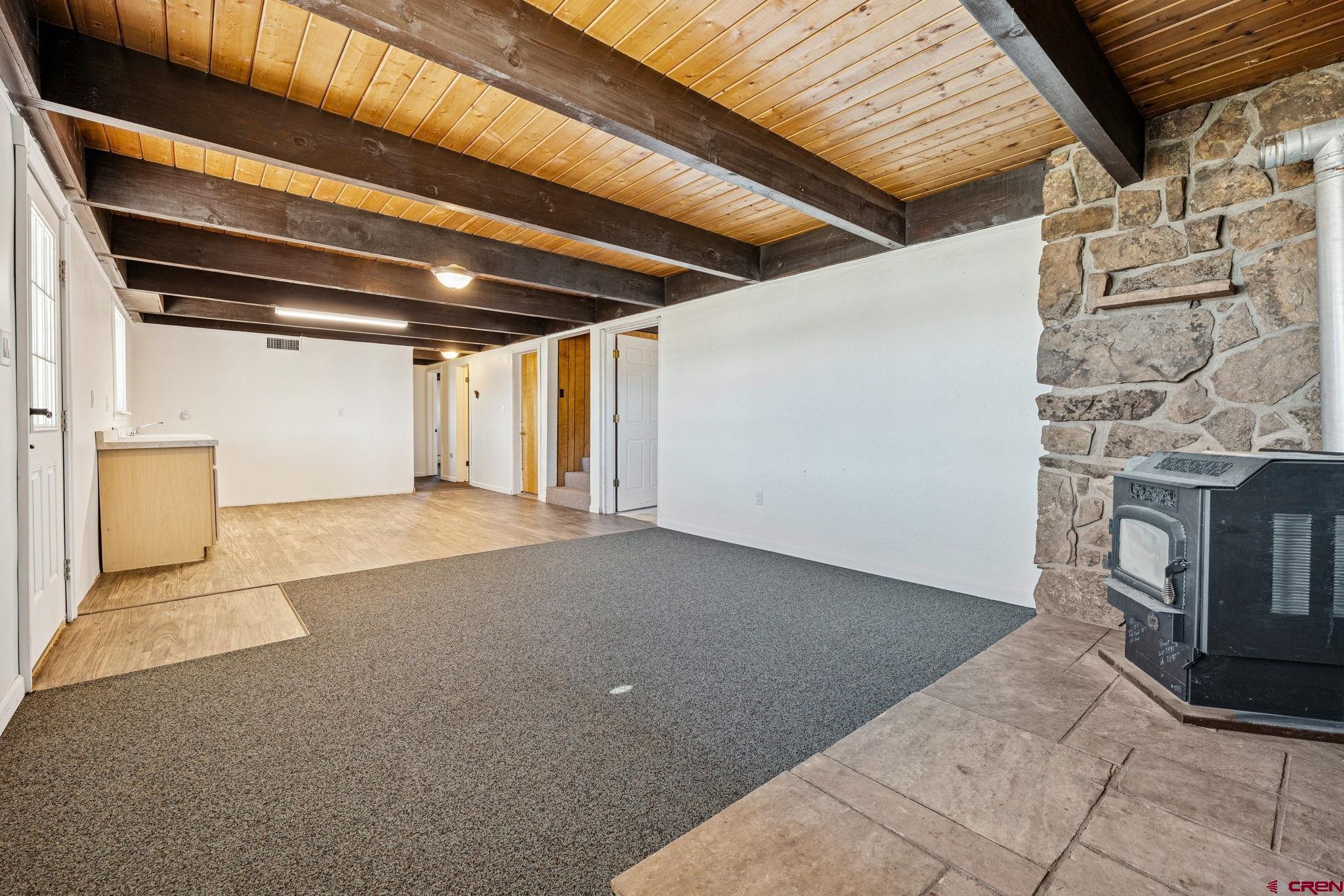 124 Meadow Road Ignacio, CO 81137 - Photo 35 of 37 a view of empty room with wooden floor and fireplace