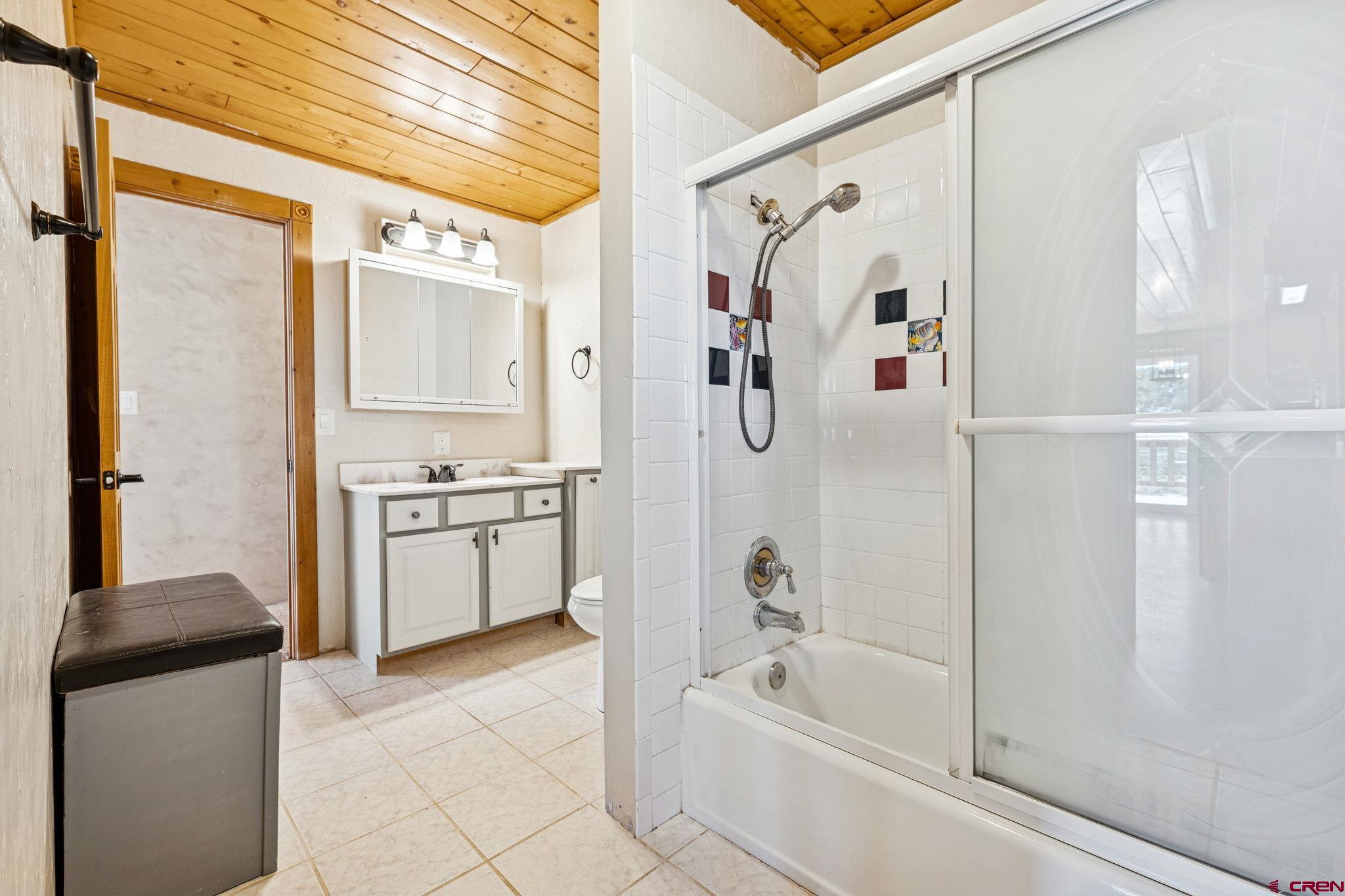124 Meadow Road Ignacio, CO 81137 - Photo 36 of 37 a bathroom with a bathtub a sink a vanity and a shower