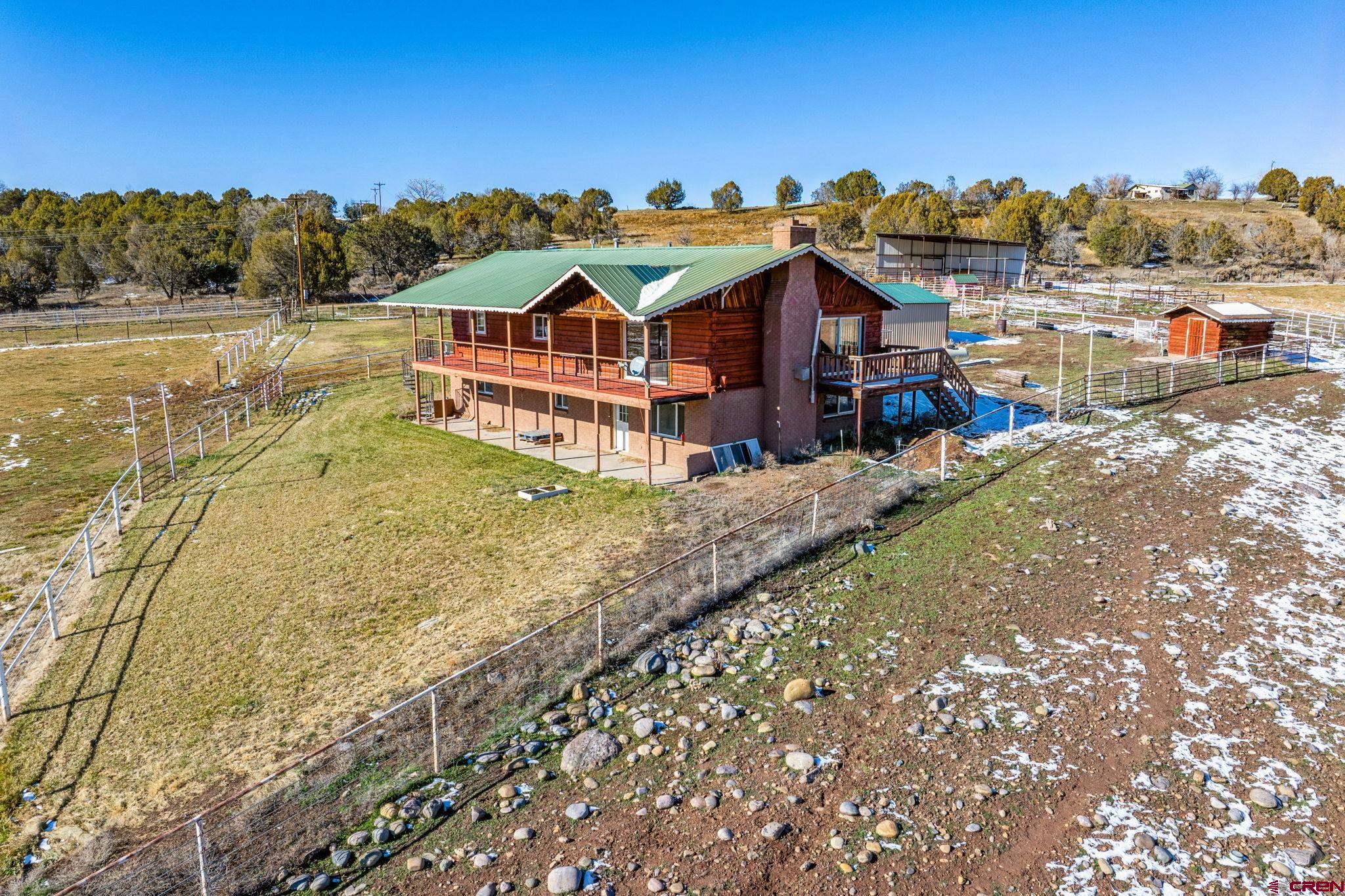 124 Meadow Road Ignacio, CO 81137 - Photo 4 of 37 a view of a large house with a big yard and large trees