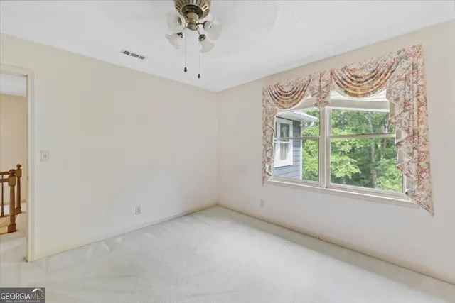 an empty room with a window and a mirror