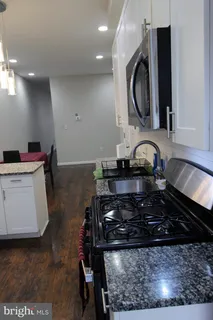 a kitchen with a stove a sink and a microwave
