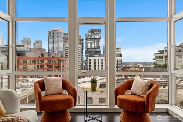 a view of a living room with furniture and a floor to ceiling window