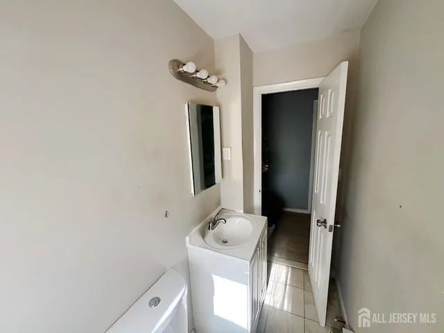 a bathroom with a sink toilet and mirror