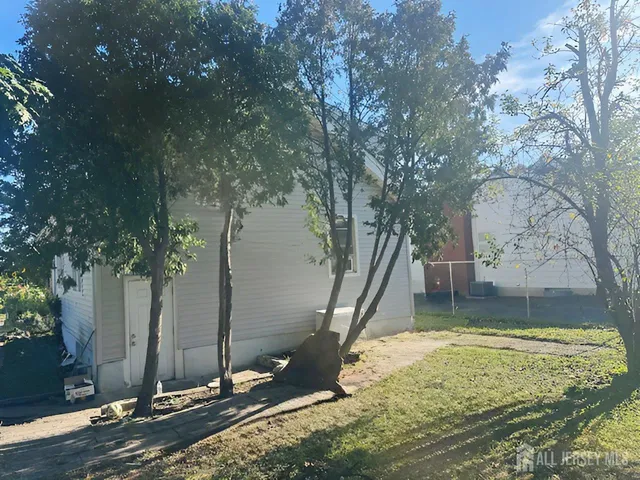 a view of a backyard with large tree