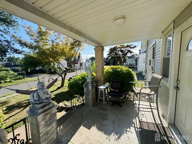 a view of balcony with chairs and potted plants