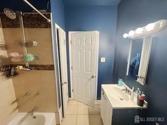 a bathroom with a sink mirror and shower
