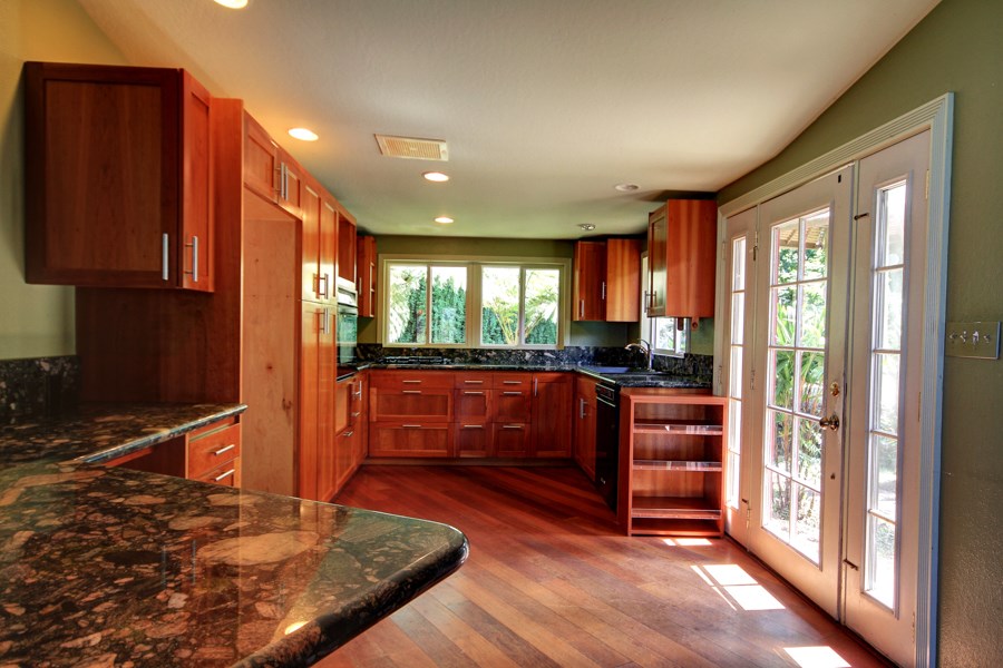 1270 Middle Road Kula, HI 96790 - Photo 6 of 17 a kitchen with stainless steel appliances granite countertop a refrigerator a stove and a sink with wooden cabinets