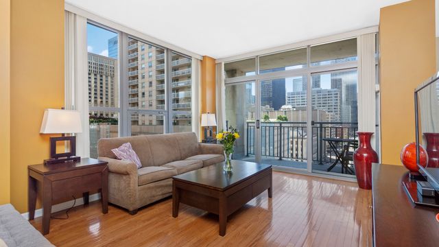 a living room with furniture and a floor to ceiling window