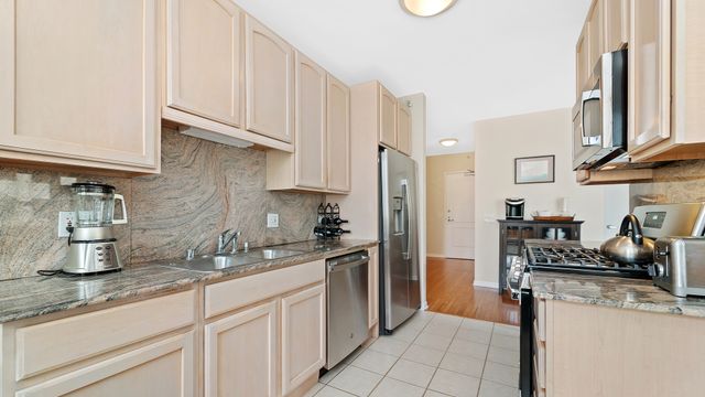 a kitchen with stainless steel appliances granite countertop a refrigerator and a sink