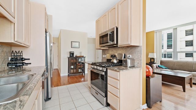 a kitchen with stainless steel appliances granite countertop a stove and a refrigerator