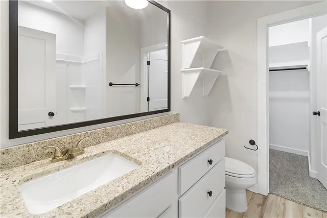 a view of kitchen with granite countertop cabinets and refrigerator
