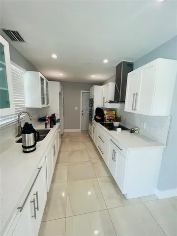a kitchen with stainless steel appliances a sink and a cabinets