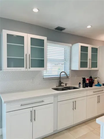 a kitchen with a sink and cabinets