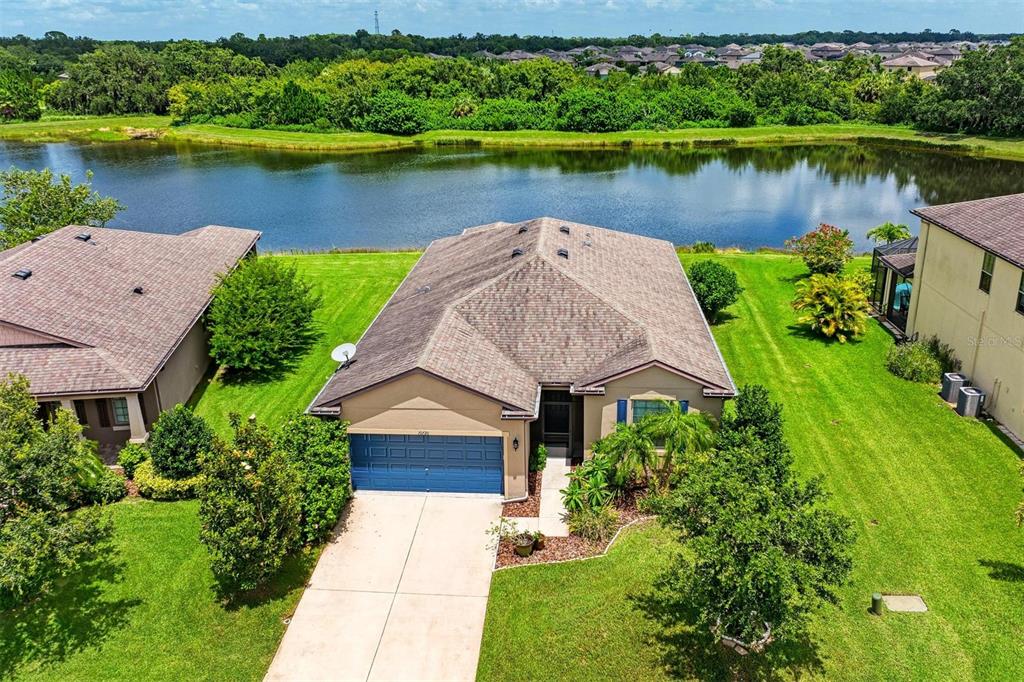 an aerial view of a house with a lake view