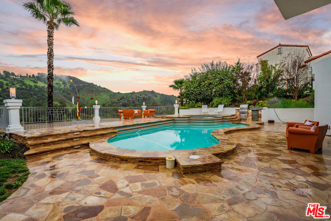 a view of a swimming pool with a lounge chairs