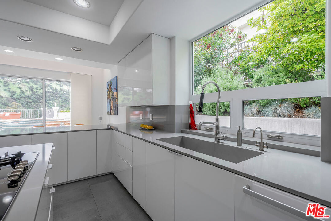 24050 Park Casino Calabasas, CA 91302 - Photo 15 of 43 a kitchen with a sink and large window